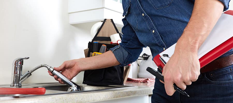 Licensed plumber inspecting plumbing during a home purchase inspection in Toronto