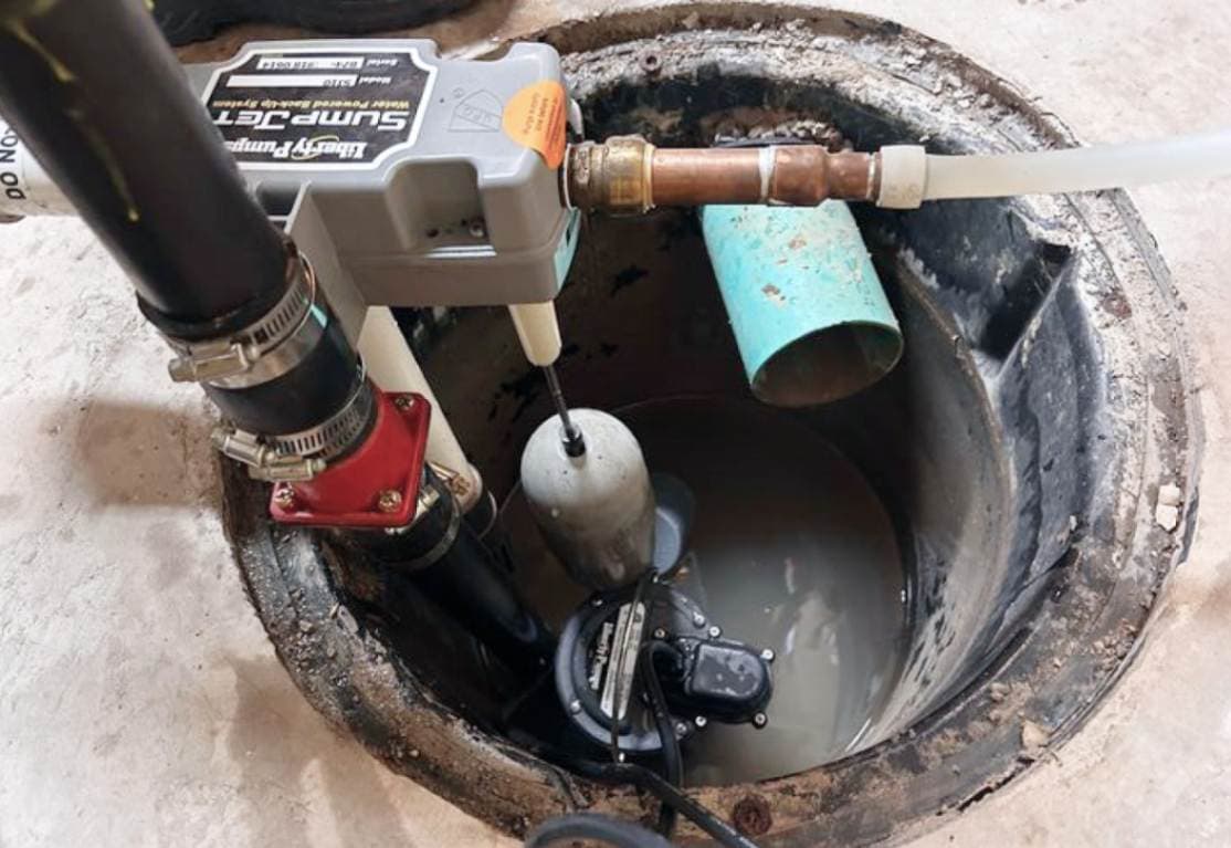 Sump pump pit in a Toronto home basement being inspected